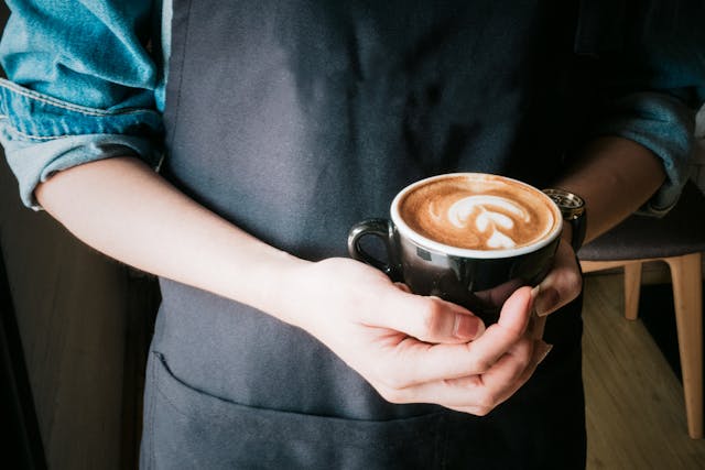 Woman Holding Mug of Cappuccino